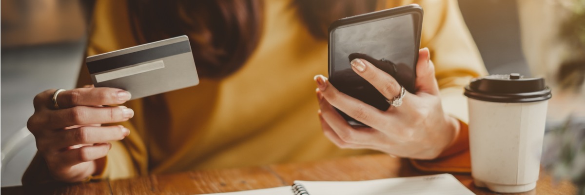 woman holding phone and credit card